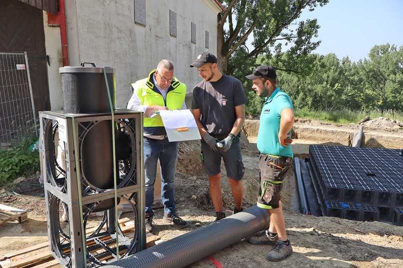 Funke-Fachberater Gerald Barth bespricht mit einem Depotec-Mitarbeiter und Leon Mayer von der Löhle Baggerbetrieb GmbH, wie die nächsten Schritte zum Einsetzen des Spülblocks aussehen. | Foto: Funke Kunststoffe GmbH