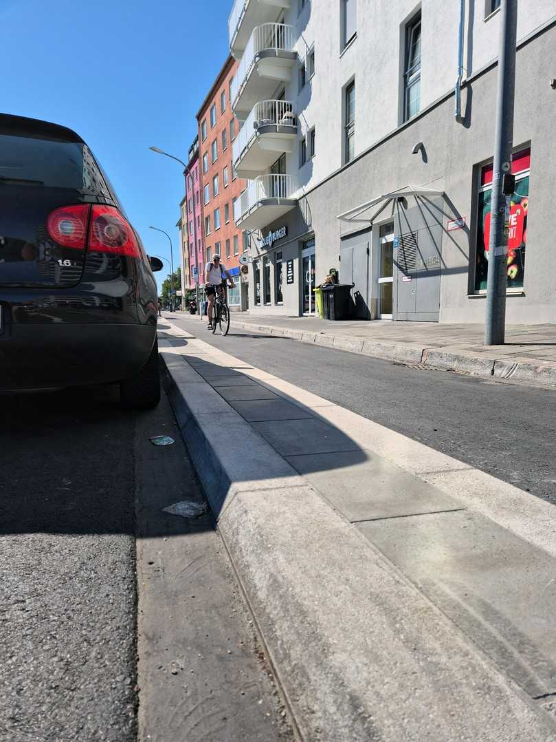Die Fahrbahntrennung mit dem Münchner Flachbordsteinsystem kann auch breiter erfolgen. Die breite Bauweise entschärft die Gefahrensituation für Radfahrer beim Öffnen der Autotüren in Richtung Radweg. | Foto: Rohrdorfer Unternehmensgruppe