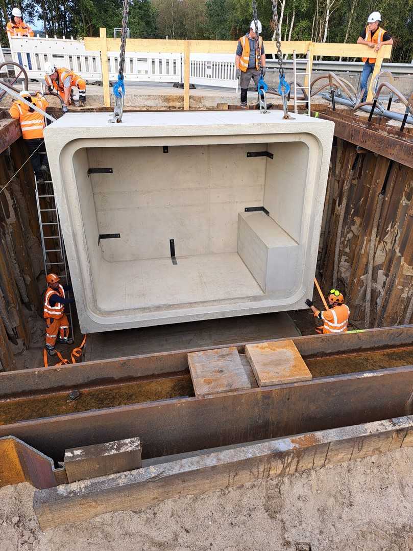 Die Stahlbeton-Fertigbauteile werden mithilfe eines Krans in die Baugrube gehoben. | Foto: Berding Beton GmbH