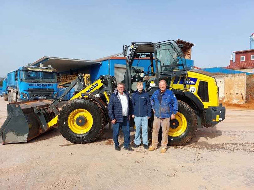 Inhaber Frank Biedermann (re.), Sohn Moritz und Kuhn Vertriebsleiter Jochen Beißwenger (li.) bei der Übergabe
des neuen Komatsu WA170M-11 auf dem Betriebshof in Bönnigheim. | Foto: Kuhn Baumaschinen